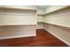 Spacious walk-in closet with wooden floors and custom shelving at 9138 Hermosa Valley St, Las Vegas, NV 89178