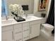 Modern bathroom features a double sink vanity, sleek faucet fixtures, a large mirror, and a contemporary toilet at 929 Hunter Shores Ave, North Las Vegas, NV 89084