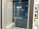 Modern tiled shower with glass doors, rain shower head, and built-in bench at 929 Hunter Shores Ave, North Las Vegas, NV 89084
