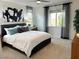 Bright main bedroom features neutral carpeting, natural light from two windows and modern decor at 929 Hunter Shores Ave, North Las Vegas, NV 89084