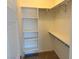 Walk-in closet features basic shelving, plenty of space for hanging clothes, and a neutral color palette at 929 Hunter Shores Ave, North Las Vegas, NV 89084