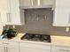 Contemporary kitchen with modern vent hood, gas range and quartz countertop at 929 Hunter Shores Ave, North Las Vegas, NV 89084