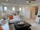 Bright living room features a modern chandelier, neutral paint and carpet, and contemporary furnishings at 929 Hunter Shores Ave, North Las Vegas, NV 89084