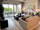 Bright living room features stylish furnishings, contemporary decor, and access to the patio through sliding glass doors at 929 Hunter Shores Ave, North Las Vegas, NV 89084