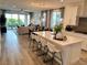 Open concept living space with a large island, modern lighting, and a sliding glass door at 929 Hunter Shores Ave, North Las Vegas, NV 89084