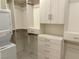 Large walk-in closet with washer and dryer, custom shelving, drawers, and hanging rods at 929 Hunter Shores Ave, North Las Vegas, NV 89084