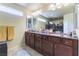 Bathroom featuring granite countertops, and sinks, and a large mirror for a luxurious feel at 9823 Belle Marie Ct, Las Vegas, NV 89141