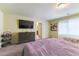 Spacious bedroom features a large-screen TV, dual twin beds, and carpeted flooring for added comfort at 9823 Belle Marie Ct, Las Vegas, NV 89141