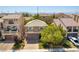 Charming two-story home with a well-manicured front yard and attached two car garage at 9823 Belle Marie Ct, Las Vegas, NV 89141