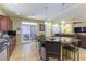 Bright kitchen featuring an island with bar seating, tile floors, and stainless appliances at 9823 Belle Marie Ct, Las Vegas, NV 89141