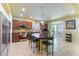 Modern kitchen with granite countertops, stainless steel appliances, and an island with seating at 9823 Belle Marie Ct, Las Vegas, NV 89141