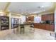 Spacious kitchen with dark wood cabinetry, stainless steel appliances, and tile flooring at 9823 Belle Marie Ct, Las Vegas, NV 89141