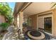 Inviting covered patio with outdoor dining table and desert landscaping creates a relaxing space at 9823 Belle Marie Ct, Las Vegas, NV 89141