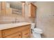 This bathroom has a marbled sink and warm tiling, along with a toilet and cabinet space at , Henderson, NV 89011