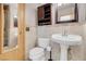 Updated bathroom with a pedestal sink, toilet, and a medicine cabinet at , Henderson, NV 89011