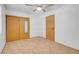A bedroom with carpet, a ceiling fan, a closet with mirrored door, and a standard door at , Henderson, NV 89011