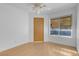 Bedroom with neutral walls, wood-look flooring, and a large window with natural light at , Henderson, NV 89011