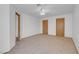 Carpeted bedroom with ceiling fan, two closets, and a door to the bathroom at , Henderson, NV 89011