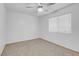 A well-lit bedroom with carpet flooring, a ceiling fan, and a window offering natural light at , Henderson, NV 89011