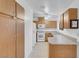 Bright kitchen with white appliances and oak cabinets with long storage cabinets at , Henderson, NV 89011