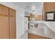 Bright kitchen with white appliances and oak cabinets with long storage cabinets at , Henderson, NV 89011