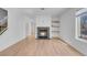 Spacious living room with fireplace, open shelving, and wood floors at , Henderson, NV 89011