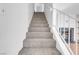 Carpeted staircase leading up, with white railing and a fireplace visible at the bottom at , Henderson, NV 89011