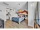 Cozy bedroom with textured walls, open bathroom, and window and natural wood floors at 1025 Willow Tree Dr # B, Las Vegas, NV 89128
