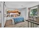 Comfortable bedroom with decoratively painted wall, large window, and closet storage solutions at 1025 Willow Tree Dr # B, Las Vegas, NV 89128