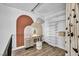 Well-organized closet space with custom shelving and decorative arched wall design and stool seating area at 1025 Willow Tree Dr # B, Las Vegas, NV 89128