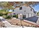 View of building with garage, landscaping and exterior lighting at 1025 Willow Tree Dr # B, Las Vegas, NV 89128