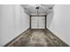 Empty garage with a functional door and lighting at 1025 Willow Tree Dr # B, Las Vegas, NV 89128