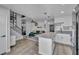 Open-concept layout showcases the kitchen, living room, and staircase with sleek black railings at 1025 Willow Tree Dr # B, Las Vegas, NV 89128