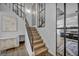 Stylish staircase with black railing, glass dividers, and landing with modern console table and decor at 1025 Willow Tree Dr # B, Las Vegas, NV 89128