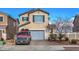 Charming two-story home featuring a neatly paved driveway, a well-maintained lawn, and an attached two-car garage at 1168 Aspen Cliff Dr, Henderson, NV 89011