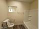 Bathroom with toilet, tub-shower, and small window at 1317 Exley Ave, Las Vegas, NV 89104