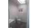 Bright bathroom features a modern vanity, skylight, toilet, and sleek gray flooring at 1317 Exley Ave, Las Vegas, NV 89104