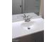 Modern bathroom sink with brushed nickel faucet and white countertop, complemented by a large mirror at 1317 Exley Ave, Las Vegas, NV 89104