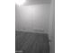Cozy bedroom with gray wood-look floors and a white air conditioning unit at 1317 Exley Ave, Las Vegas, NV 89104