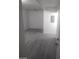 Cozy bedroom with gray wood-look floors and a white air conditioning unit at 1317 Exley Ave, Las Vegas, NV 89104