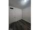 Clean bedroom featuring gray wood-look floors and a white door at 1317 Exley Ave, Las Vegas, NV 89104