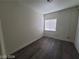 Neutral bedroom with wood-look floors and a window with blinds at 1317 Exley Ave, Las Vegas, NV 89104