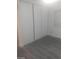Bedroom closet featuring gray wood-look floors and a white sliding doors at 1317 Exley Ave, Las Vegas, NV 89104