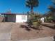 Charming single-story home featuring mature palm trees and a covered carport at 1317 Exley Ave, Las Vegas, NV 89104
