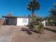 Charming single-story home featuring mature palm trees and a covered carport at 1317 Exley Ave, Las Vegas, NV 89104
