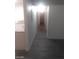 Bright hallway leading to kitchen and rooms with gray wood-look floors at 1317 Exley Ave, Las Vegas, NV 89104