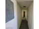 A long hallway with plank floors has access to two rooms and a flush ceiling light at 1317 Exley Ave, Las Vegas, NV 89104