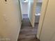 A hallway with plank floors leads to an adjacent room and the bathroom at 1317 Exley Ave, Las Vegas, NV 89104