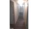 Bright hallway featuring gray wood-look floors and white walls at 1317 Exley Ave, Las Vegas, NV 89104