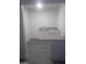 Bright kitchenette featuring granite countertops and white cabinetry with gray wood-look floors at 1317 Exley Ave, Las Vegas, NV 89104